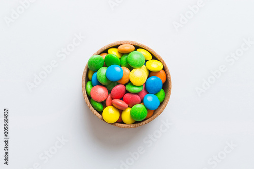 Tableau sur toile Multicolored candies in a bowl on a colored background