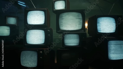 Vintage televisions stacked in a dark room, creating a nostalgic atmosphere. Represents the evolution of media and technology in entertainment