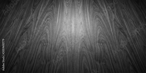 Photos A close-up, black and white, detailed shot of dark wood grain with a spotlight effect