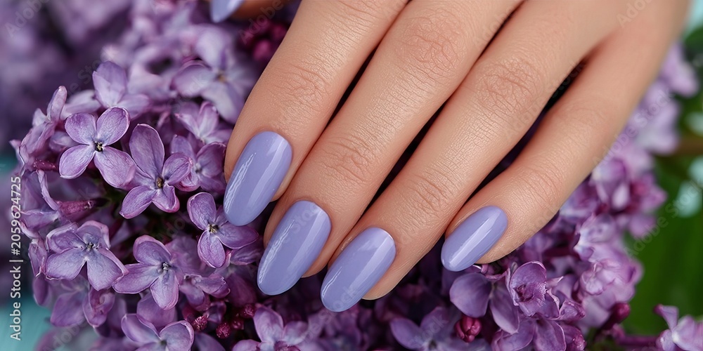 Fototapeta premium Closeup of a Woman s Hand with Stylish Purple Lavender Nails Surrounded by Beautiful Summer Flowers