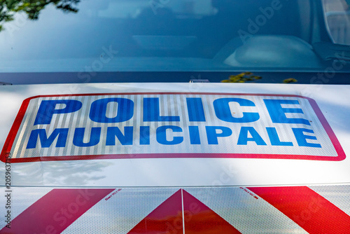 Close-up of “Police Municipale” signage on a French municipal police patrol vehicle, representing local law enforcement, urban safety and public security in Paris, France.