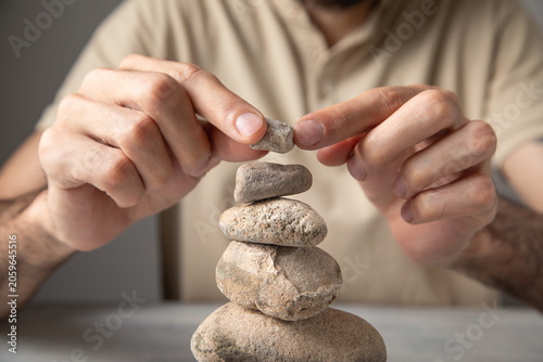 Photography Man stacking stones. Balancing stones