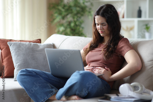 Obraz na płótnie Student complaining suffering belly ache learning at home