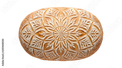 Round artisanal sourdough bread loaf with elaborate leaf pattern scoring sourdough homemade carbohydrate breakfast traditional preparation nutrition delicious fermented boulangerie