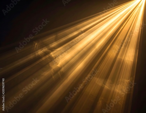 Golden light rays shining in darkness.