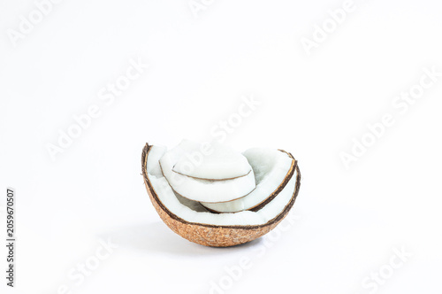 Fresh coconut cut into slices and halves on a clean white background. Coconut, Minimal, natural look, ideal for food, health, and organic ingredient concepts