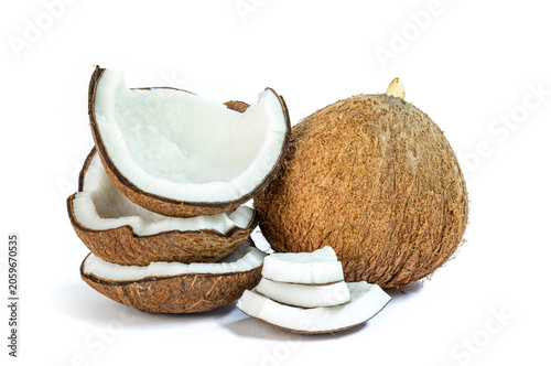 Whole mature coconut and multiple sliced halves on white background, Coconut, showing thick white flesh and brown shell, ideal for food, health, and natural ingredient concepts