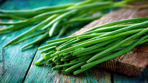 Fresh green stalks of garden herbs rest upon rustic wooden surfaces