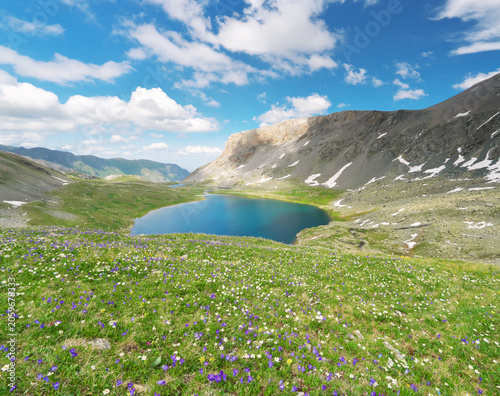 Beautiful Mountain Valley With Alpine Meadow Green Grass And Glacial Lakes Under Blue Cloudy Sky
