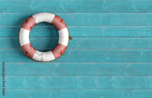 Lifebuoy hanging on blue wooden wall offering safety