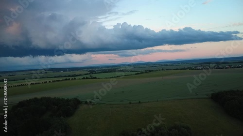 Aerial drone view of massive storm clouds moving across the landscape. The video captures dramatic weather patterns, shifting cloud formations, and the powerful atmosphere of an approaching storm from
