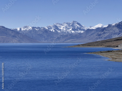 Snowcapped mountain peak across tso moriri lake in Ladakh. Himalayan background with copy space