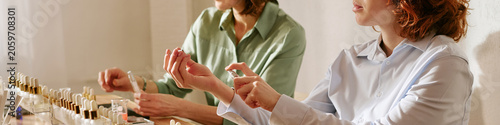 Obraz na płótnie Website banner of women testing perfume samples and spraying fragrance on wrists