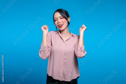 Happy Asian Woman Enjoying Music and Dancing