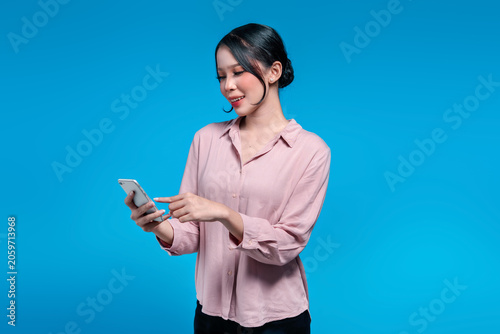Young Asian Woman Pointing at Smartphone Screen with a Smile