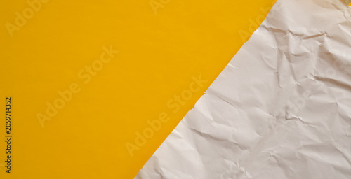 Minimalist Abstract Background with Yellow Surface and Crumpled White Paper