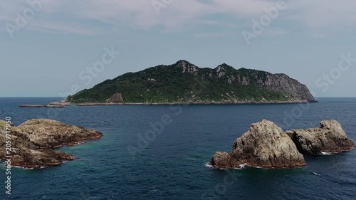 Drone footage of Okinoshima Island surrounded by blue ocean