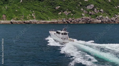 Aerial view of a vessel passing by Okinoshima Island