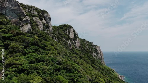 Drone footage of a boat near the rugged coast of Okinoshima