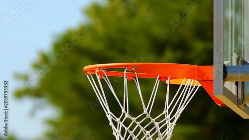 Basketball shooting towards the hoop in a vibrant outdoor setting. Capturing the excitement and energy of sports and teamwork