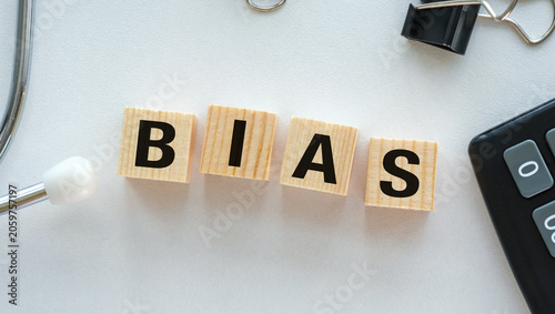 Foto Wooden blocks spell BIAS on a clean white surface