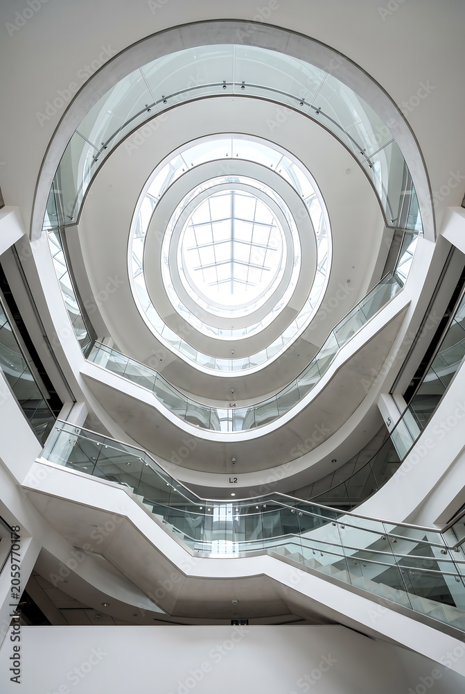 Fototapeta premium Modern Spiral Staircase in a Premium Business Building with Glass Railings and Bright Natural Light