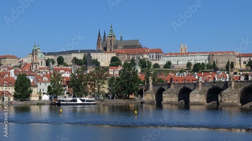City of Prague at Vltava river in Czechia (Czech Republic). View to the Charles Bridge and Prague Castle on a hill, zoom in.