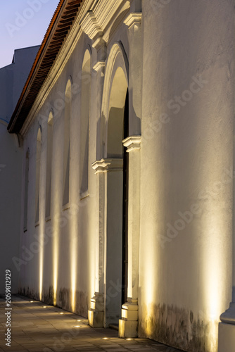 Old quarter architecture illuminating the colonial Cathedral building facade with modern spotlights at dusk, highlighting the historical charm of Casco Viejo, Panama city - stock photo