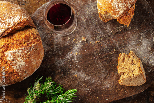 Homemade artisan sourdough bread loaf on a rustic wooden cutting board