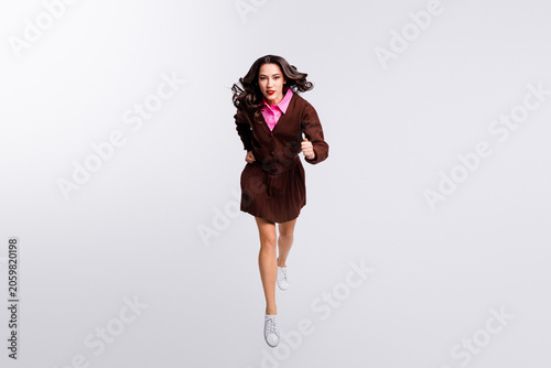 Fényképezés Confident young businesswoman running energetically in stylish casual attire on