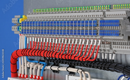 Marking electrical wiring wires with thermally printed nylon tape. 