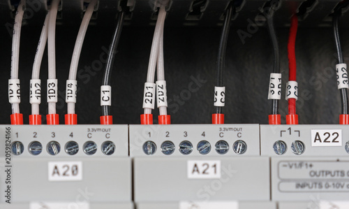 Marking electrical wiring wires with thermally printed nylon tape. 