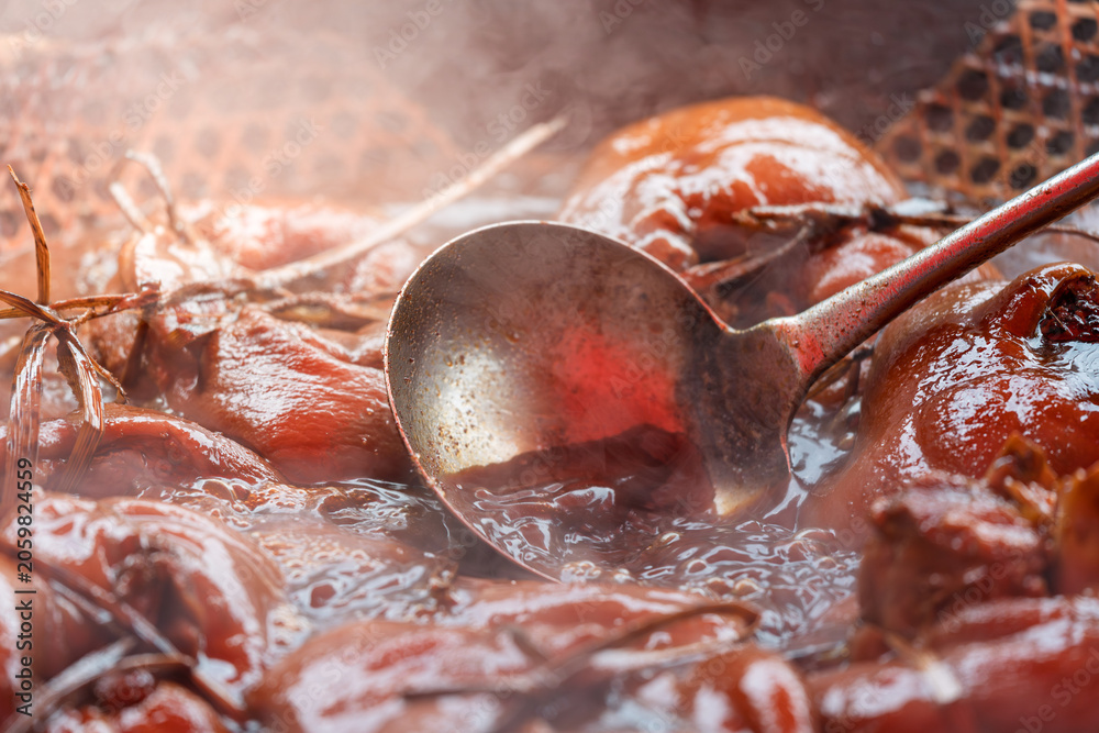Fototapeta premium traditional braised soy sauce pork trotters steaming hot served in pot