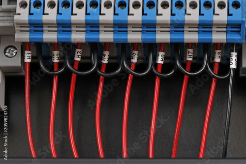 Marking electrical wiring wires with thermally printed nylon tape. 