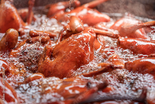 Photography traditional braised soy duck immersed in savory sauce cooking scene