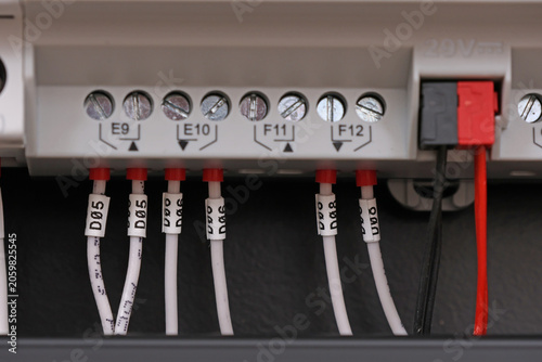 Marking electrical wiring wires with thermally printed nylon tape. 