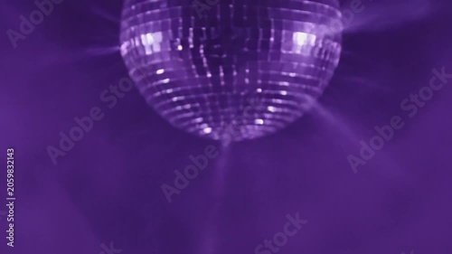 Purple Disco Ball Spinning with Light Beams and Smoke