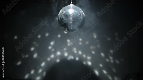 Disco Ball Spinning and Reflecting Light in Smoky Atmosphere