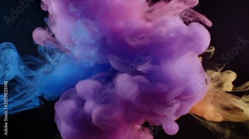 Colorful Ink Clouds Colliding and Swirling in Water, Abstract Motion