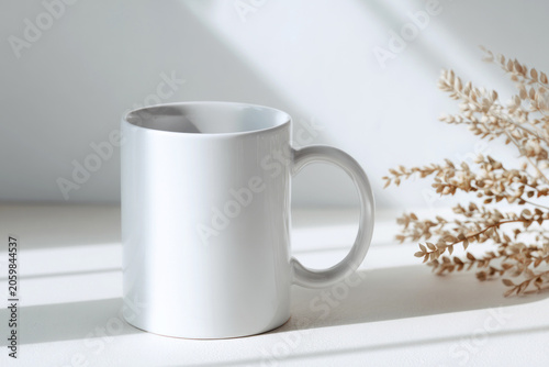 Close-up white ceramic mug mockup placed on clean white tabletop