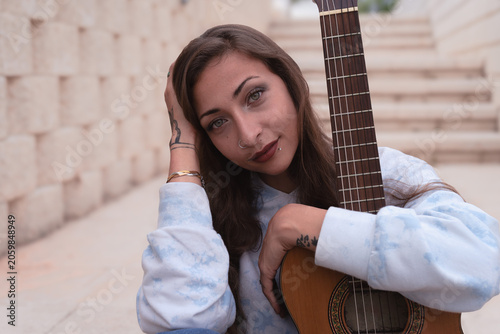 Young musician posing with guitar embracing creative individuality
