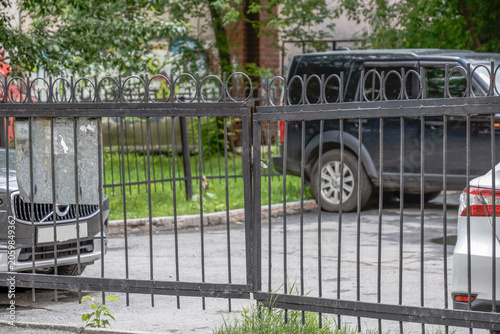Closed iron parking gates on a summer day