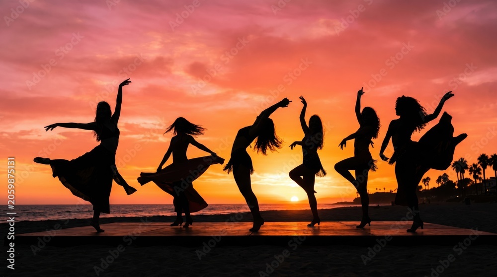 Fototapeta premium Silhouettes of women dancing gracefully on a stage by the sea during a golden sunset. Group of girls performing a choreographed dance routine. Tropical beach vacation and summer party lifestyle.