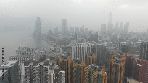 Drone flight of Hung Hom district and modern skyline of Hong Kong on foggy misty day
