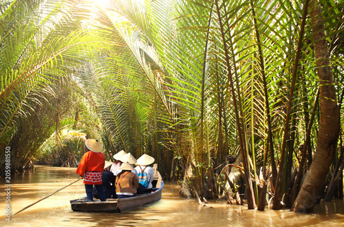 Tableau sur toile People boating in the delta of Mekong river, Vietnam, Asia