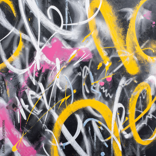 Abstract graffiti artwork featuring vibrant colors and dynamic brush strokes with yellow, pink, and black paint on a textured surface creating an urban aesthetic