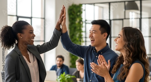 Diverse business colleagues celebrate success with a high-five and cheers, fostering teamwork and positive collaboration in a modern office environment