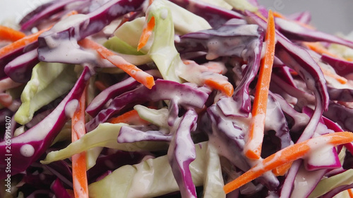 Fresh coleslaw salad close-up, shredded red cabbage and carrots, crunchy raw vegetable mix for healthy eating