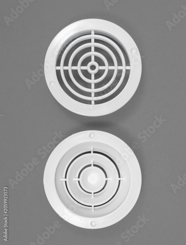 Photos White ventilation grate on a gray background