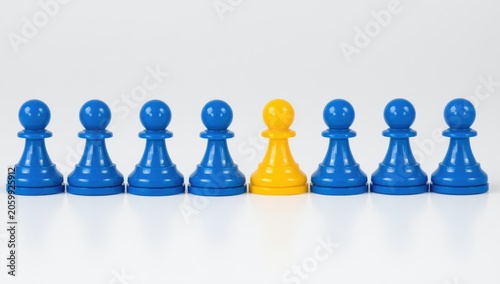 One yellow chess pawn standing out among many blue pawns in a straight row